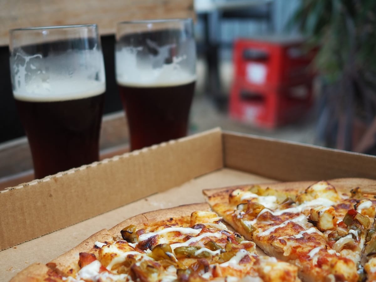 Two pints of brown ale and a paneer pizza.