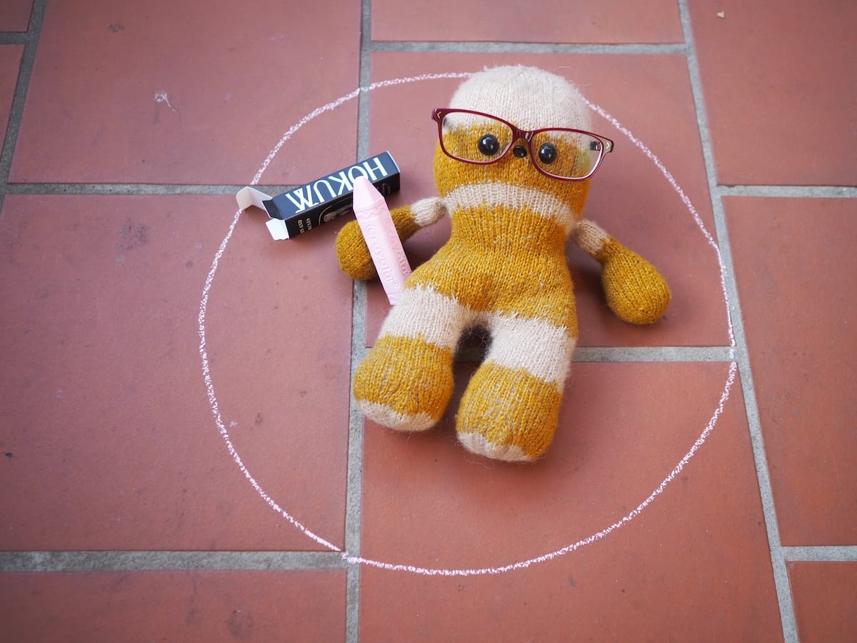 Knitted Chewbacca inside a pink chalk circle