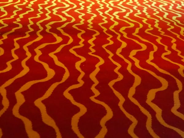Red carpet with pale wiggly lines