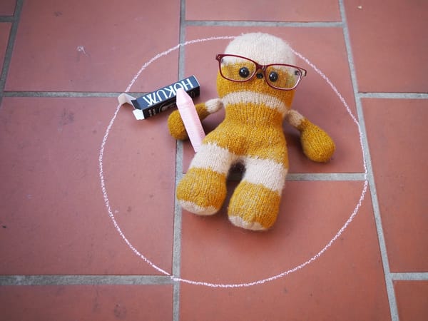 Knitted Chewbacca inside a pink chalk circle
