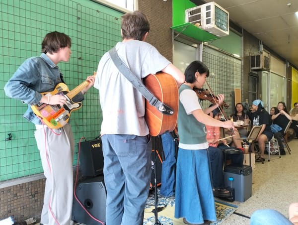 A band playing in an old retail arcade.